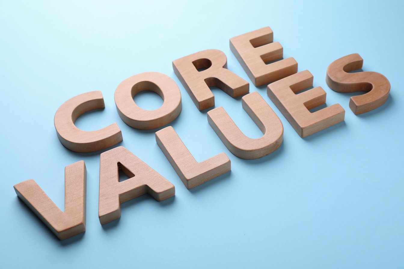 Phrase CORE VALUES Made of Wooden Letters on Light Blue Background